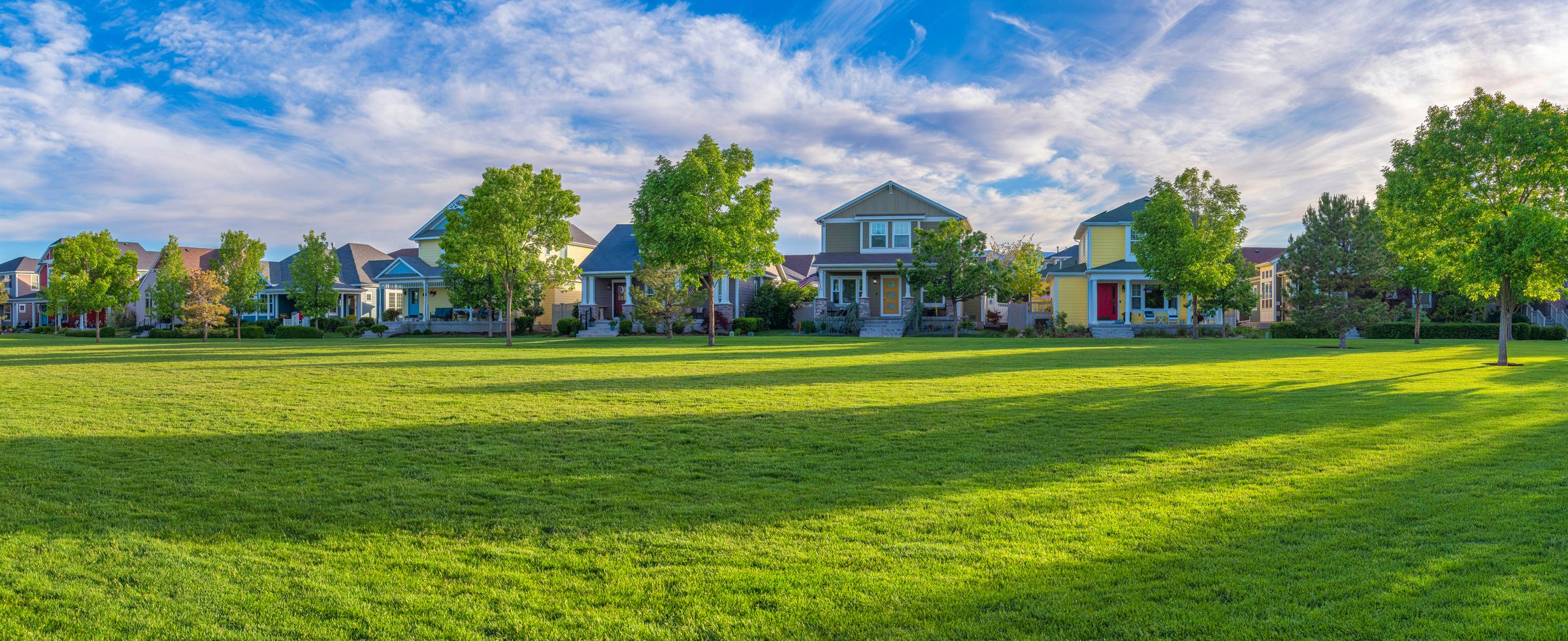 Row of homes facing a green lawn